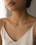Model wearing the Dainty Layering Chain with an ivory camisole
