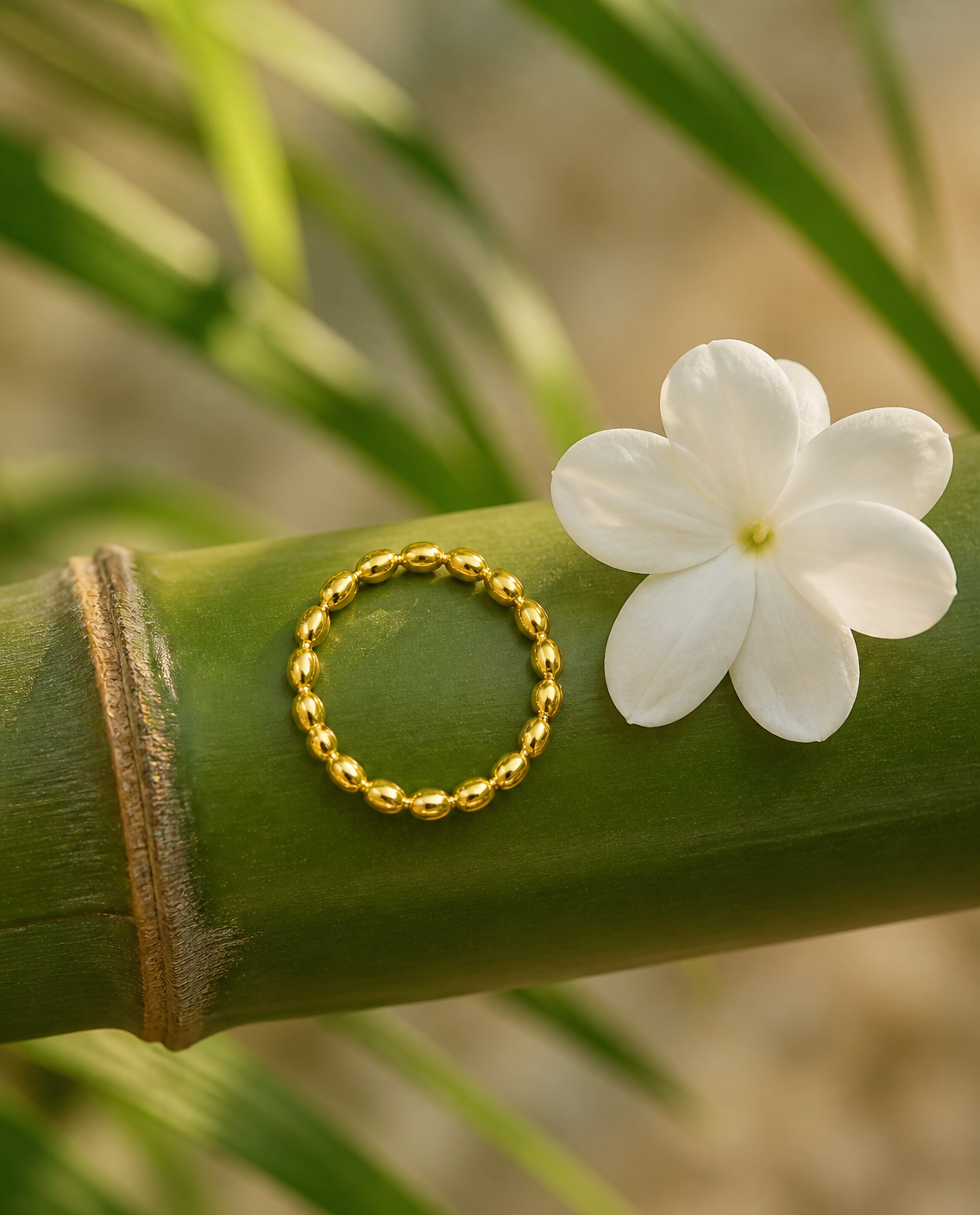 Beaded gold ring on bamboo with sampaguita