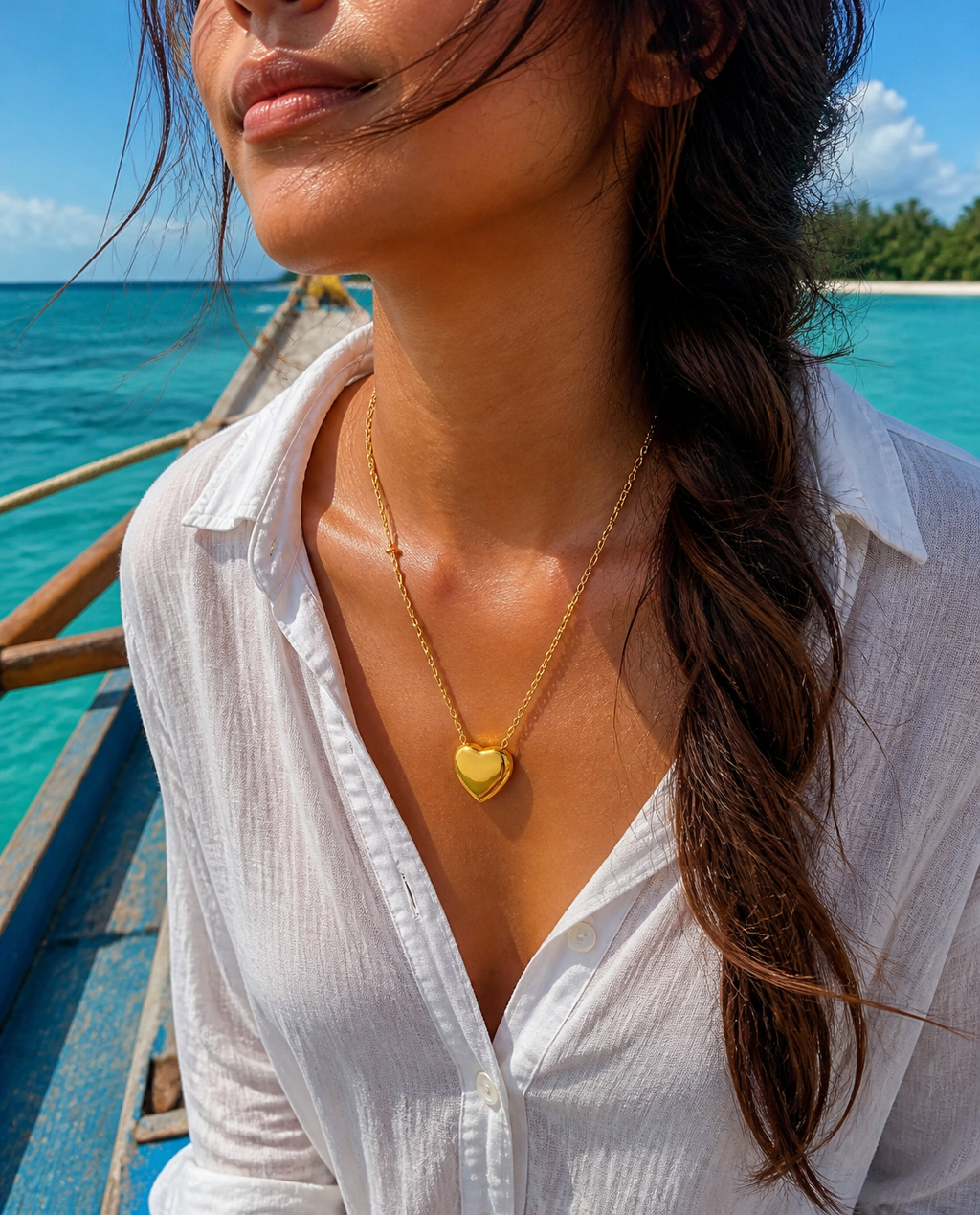 Puffy Heart Necklace worn by a model on a bangka boat