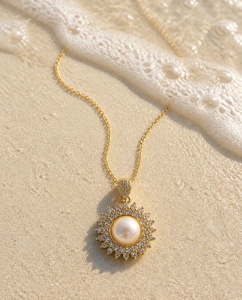 Pearl Sunburst Necklace on wet sand with sea foam