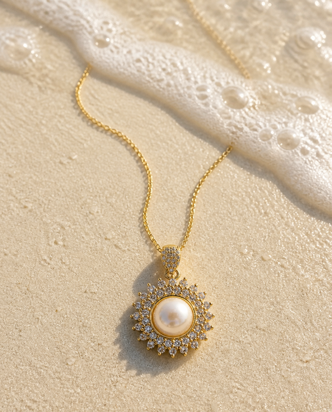 Pearl Sunburst Necklace on wet sand with sea foam