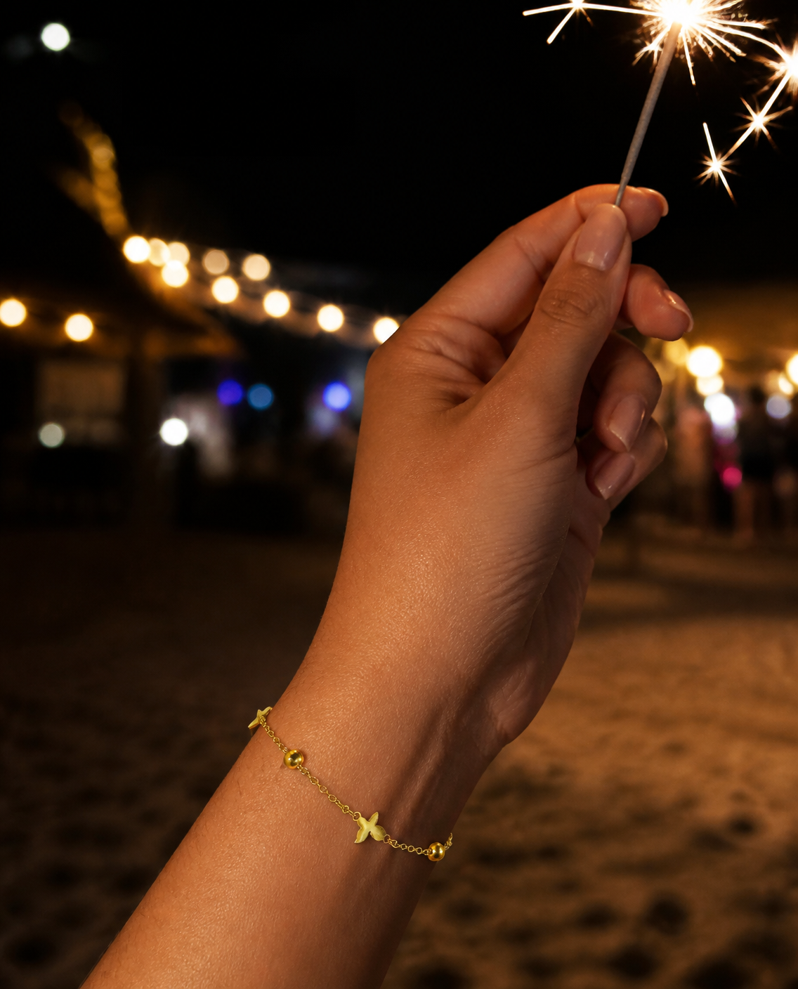 Scattered Star Bracelet worn holding a sparkler