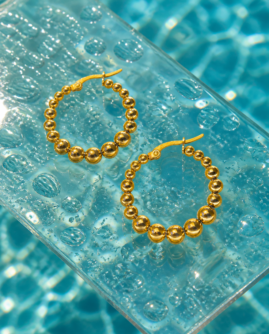 Beaded Bubble Hoops on glass with water droplets