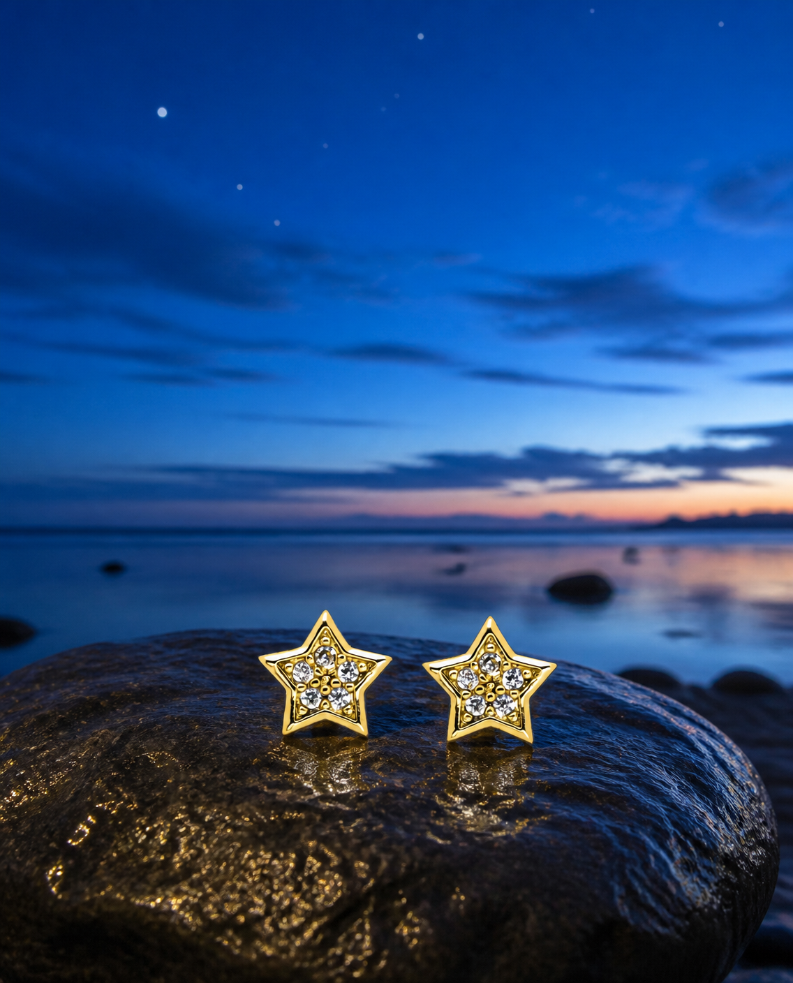Sparkle Star Stud Earrings on a beach stone at blue hour