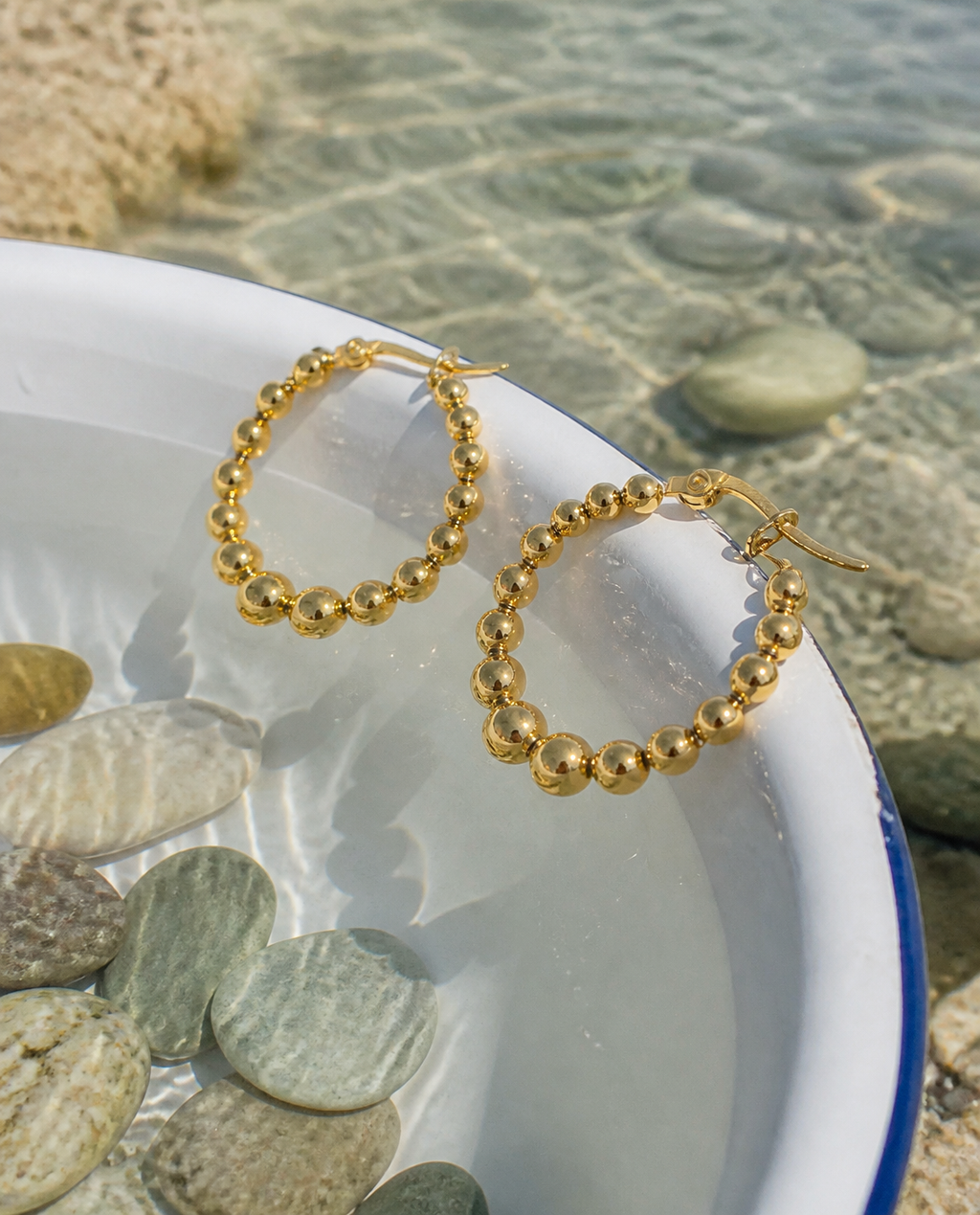Beaded Bubble Hoops on an enamel basin of seawater