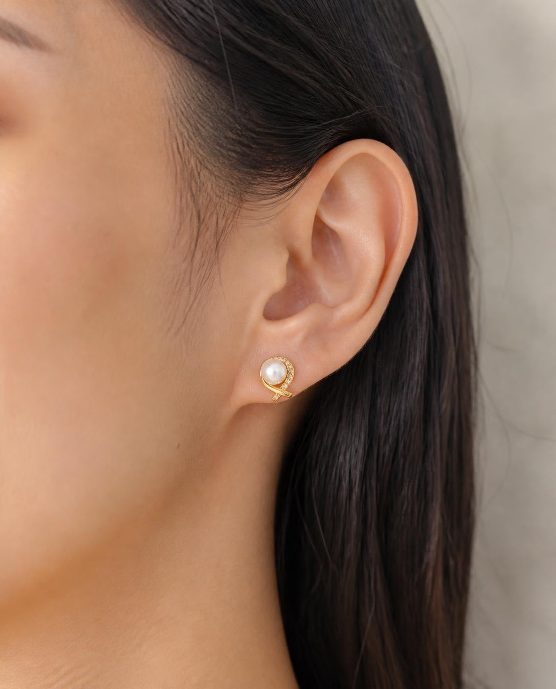 Side profile of a model wearing the Pearl Wrap Stud Earrings