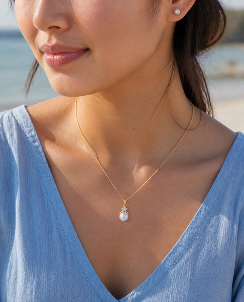 Model wearing the Pearl Star Pendant Necklace with a chambray top