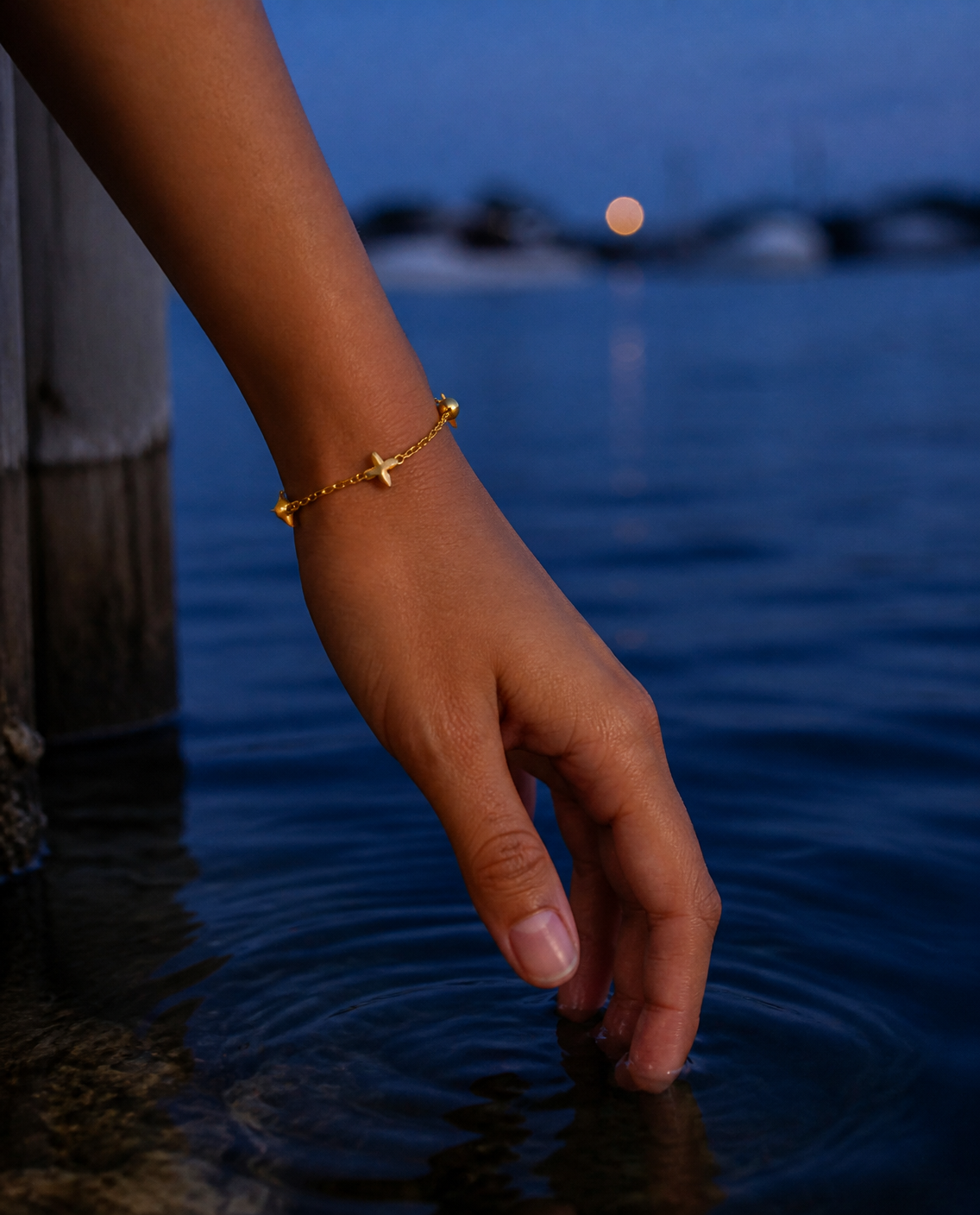 Scattered Star Bracelet worn at blue hour on a jetty