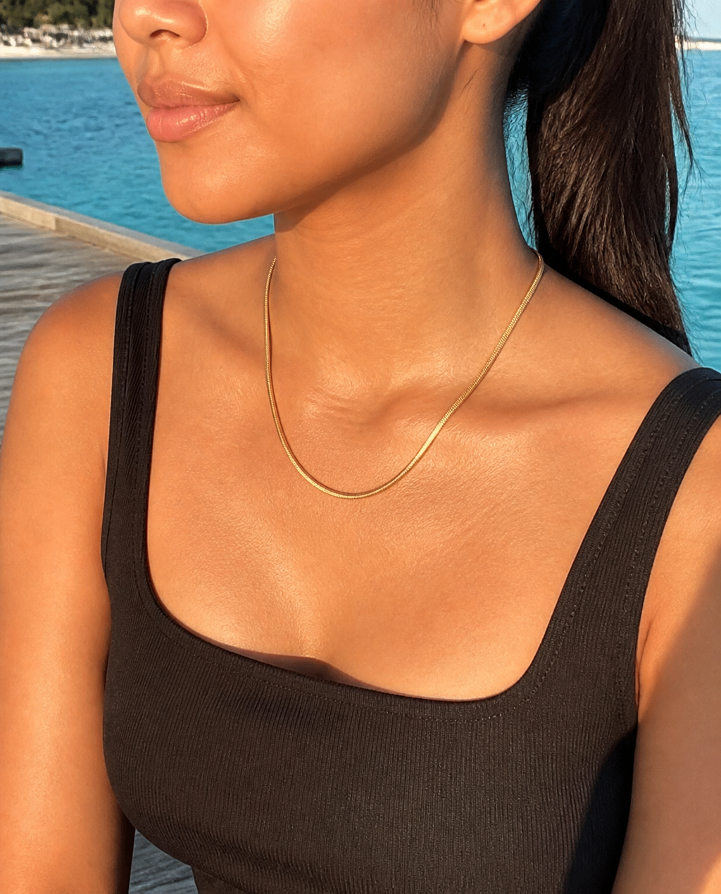 Dainty Layering Chain worn by a model on a jetty