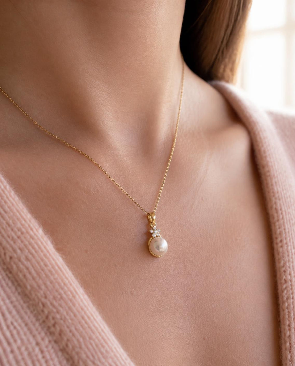 Close-up of the Pearl Star pendant on the collarbone